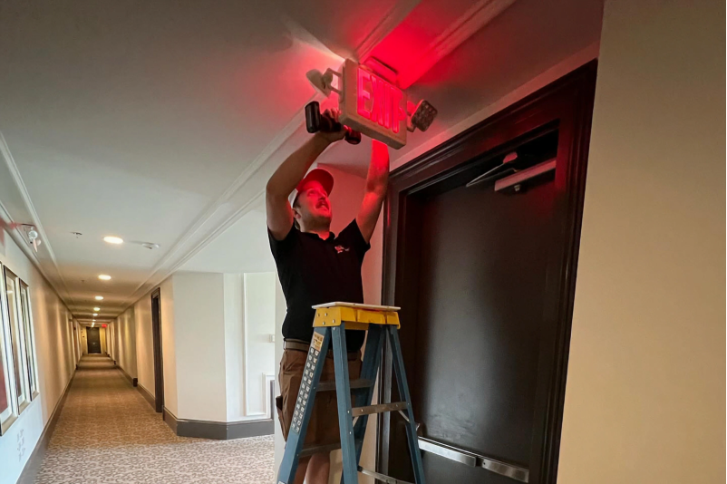 emergency exit light installation in progress